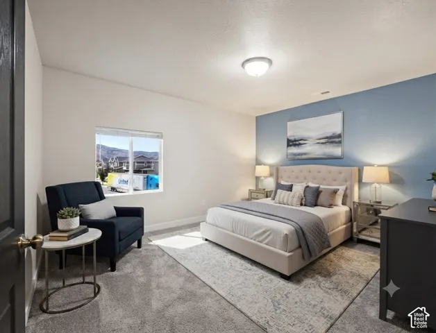 Spacious room featuring a large window, plush carpeting, light blue accent wall, and a ceiling-mounted light fixture