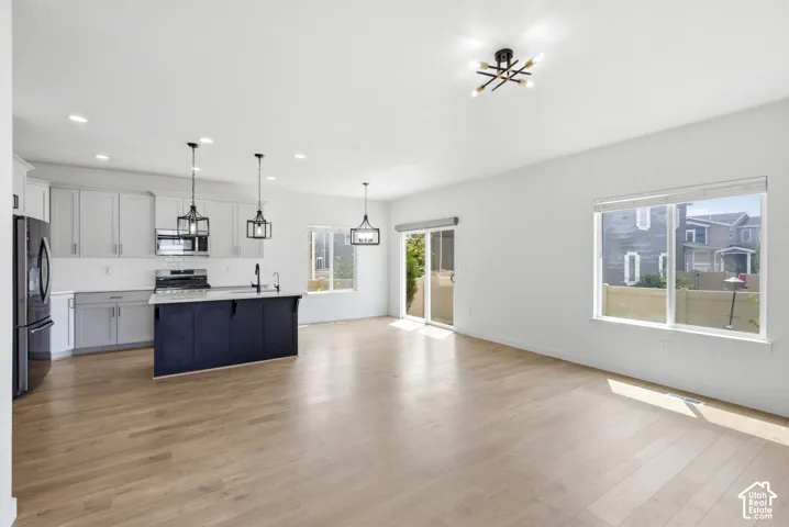 Open-concept living area with light wood-finish flooring
