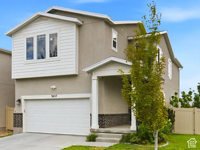 Two-story residence featuring a stucco and horizontal siding exterior