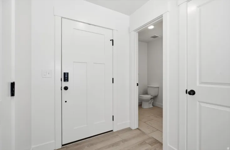 Entryway featuring light wood-finish flooring and white walls