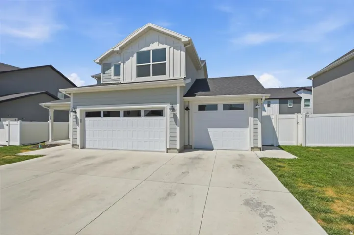Contemporary residential exterior featuring light gray siding and white trim accents
