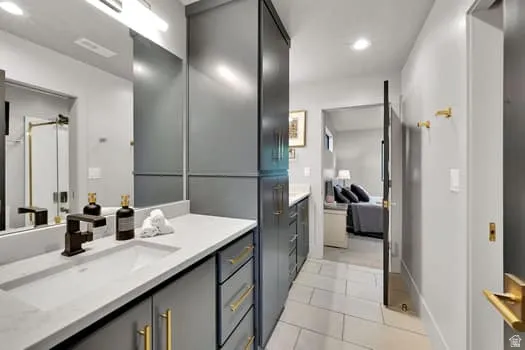 Bathroom vanity with an integrated rectangular sink, light-toned countertop, and matte black faucet