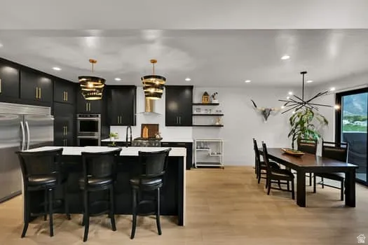 Modern kitchen and dining area with light wood-finish flooring