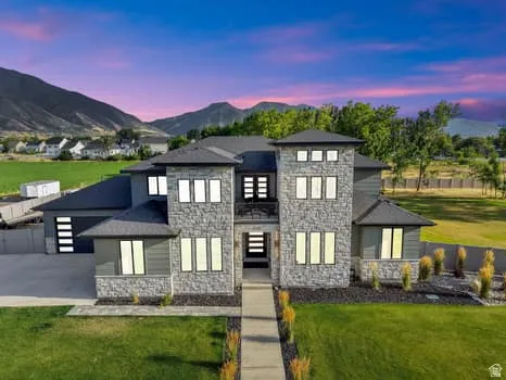 Modern architectural residence featuring a stone and siding exterior