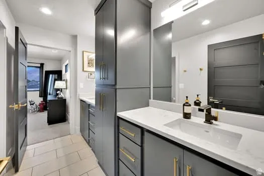 Dual vanity with quartz countertops, integrated rectangular sinks, and matte black faucets