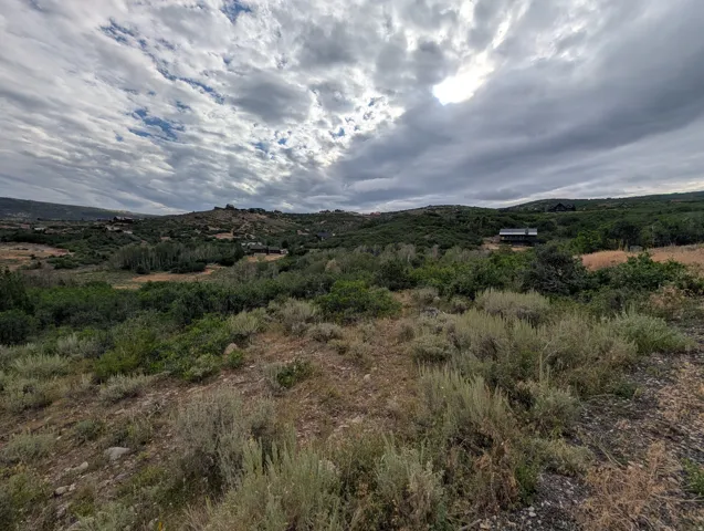 Expansive natural landscape featuring varied terrain and distant structures