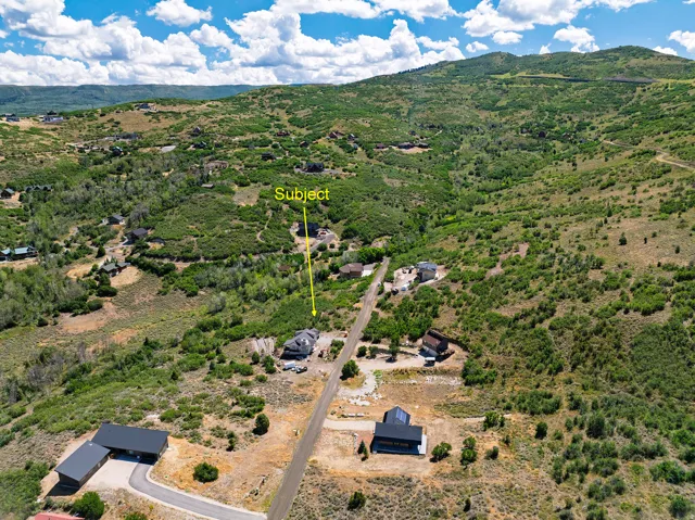 Hilly terrain with natural vegetation surrounding the property