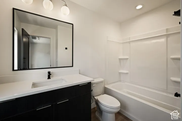 Modern bathroom featuring a vanity with a white countertop, undermount sink, and black faucet