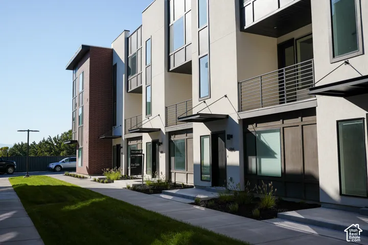 Modern multi-unit residential building featuring clean-lined architecture with mixed material exterior cladding in brick and stucco