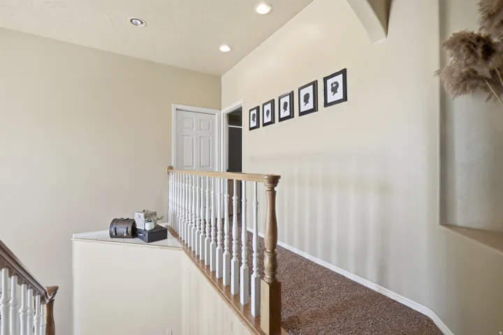 Staircase featuring wood railings and white spindles