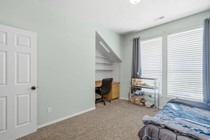 Built-in shelving, dual pane windows, and a panel door with dark hardware