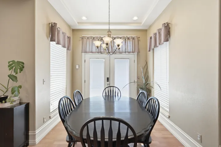 Recessed lighting, light wood-finish flooring, and white trim