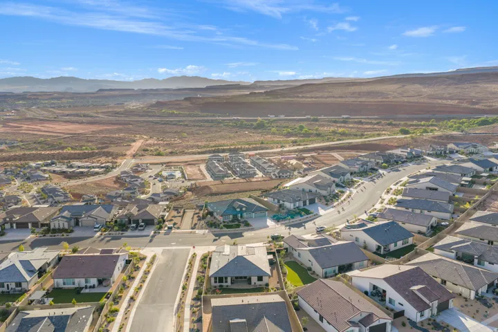 Aerial perspective showcasing a residential community with varied rooflines and a clear sky backdrop
