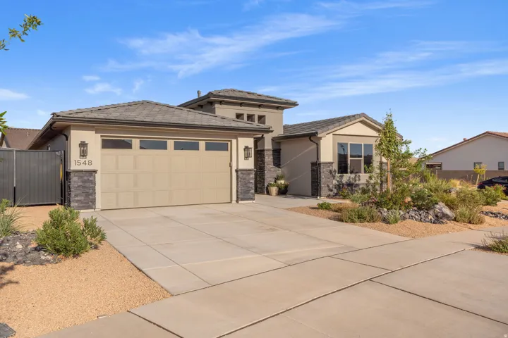 Contemporary stucco exterior with stone accents and a two-car garage