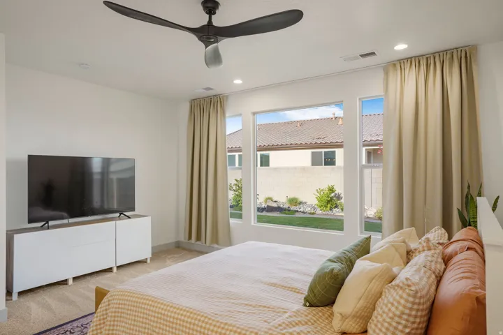 Room featuring abundant natural light from multiple windows, recessed ceiling lights, and a ceiling fan