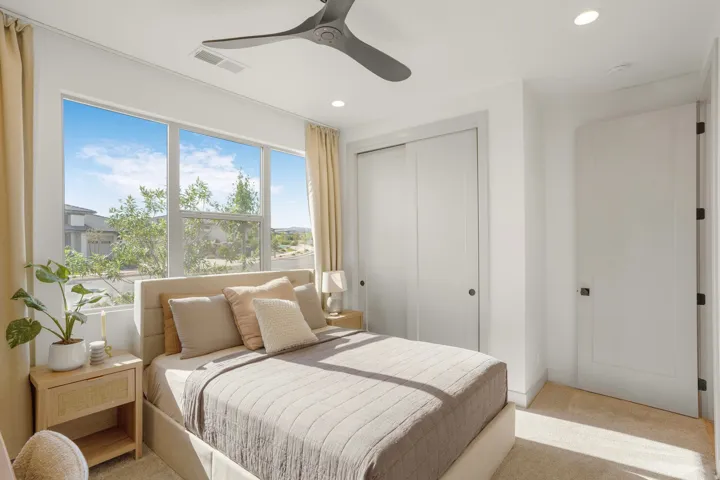 Bedroom featuring expansive windows, recessed lighting, a ceiling fan, and a neutral color palette