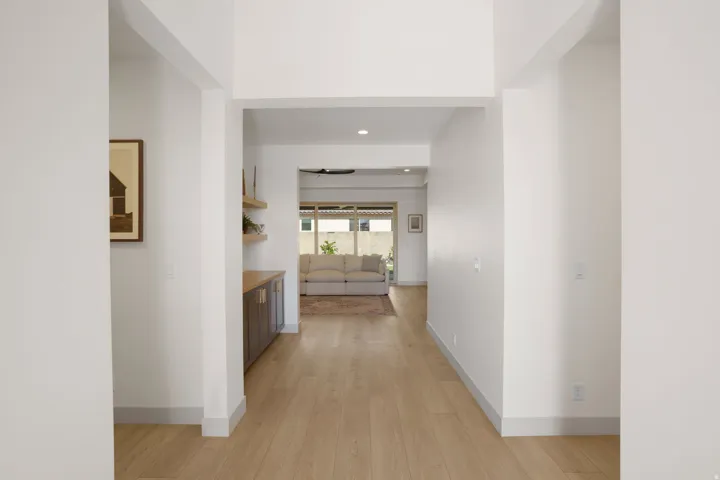 Light wood-finish flooring extending through an open hallway