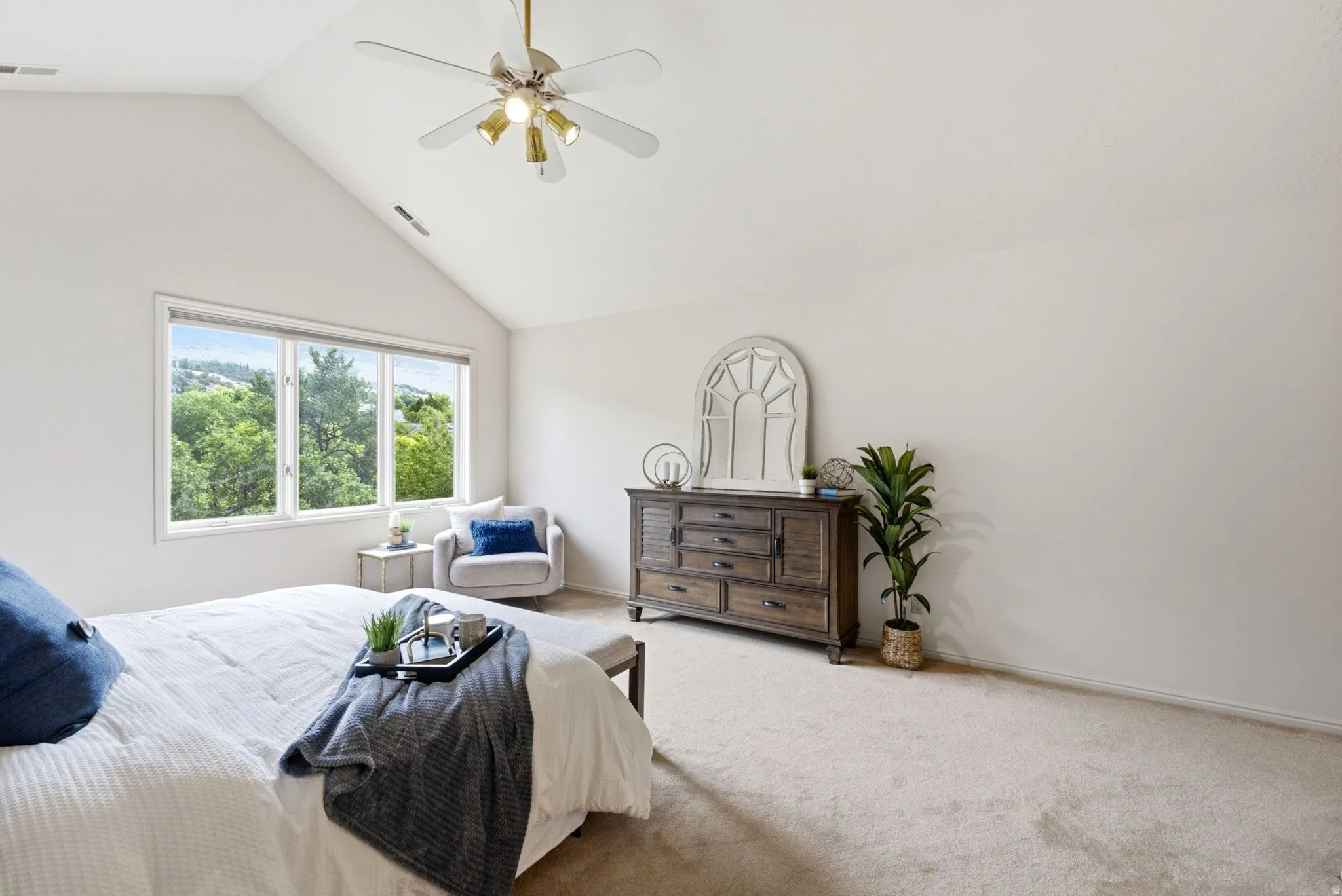 Spacious room with vaulted ceilings and a multi-pane window