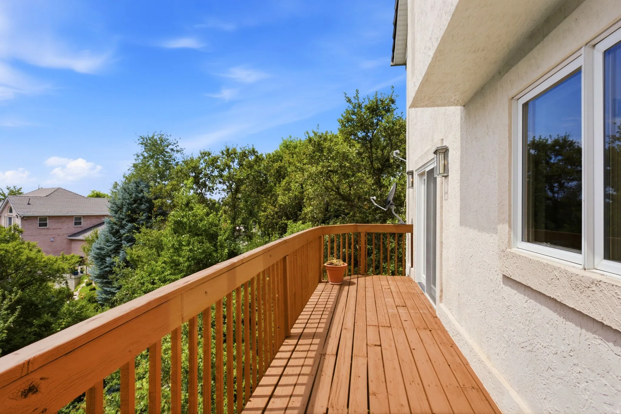 Exterior deck featuring wood-finish flooring, a wood railing, and a sliding glass door