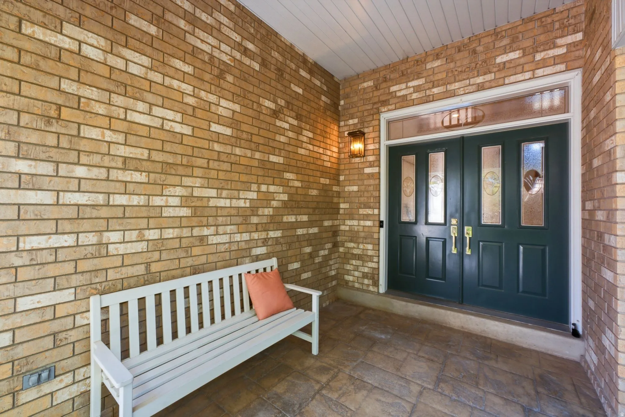 Entryway featuring double doors with decorative glass panels, a transom window, and an overhead light fixture