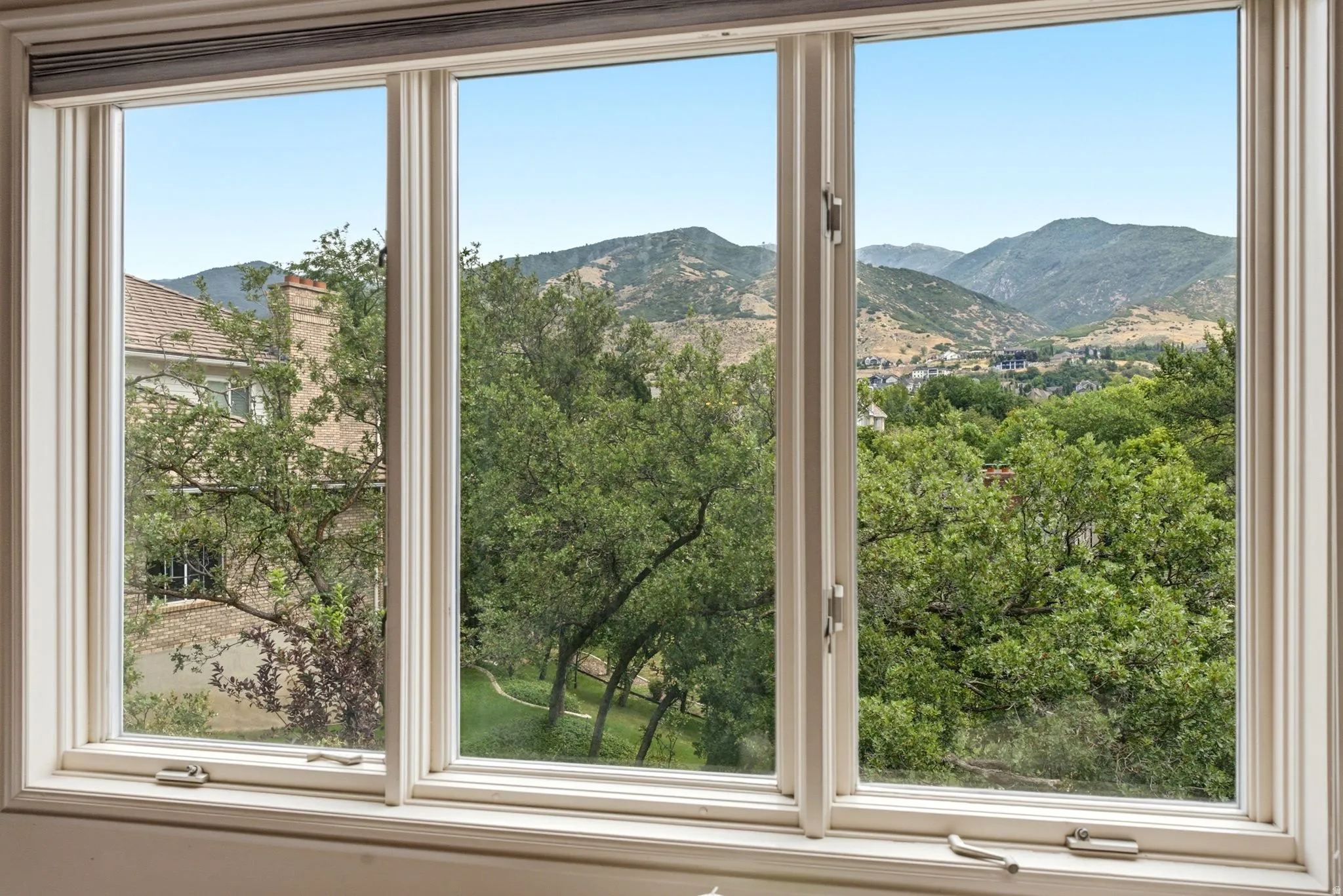 Triple pane windows showcasing mountain and tree scenery