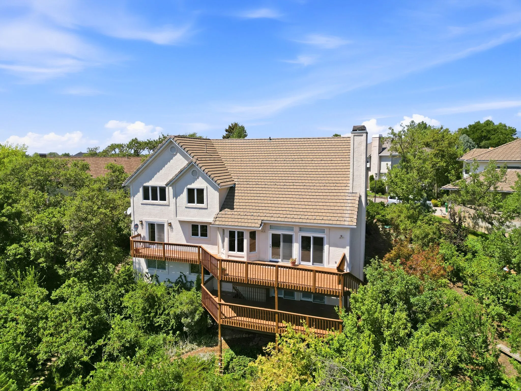 Multi-level stucco exterior with a tiled roof