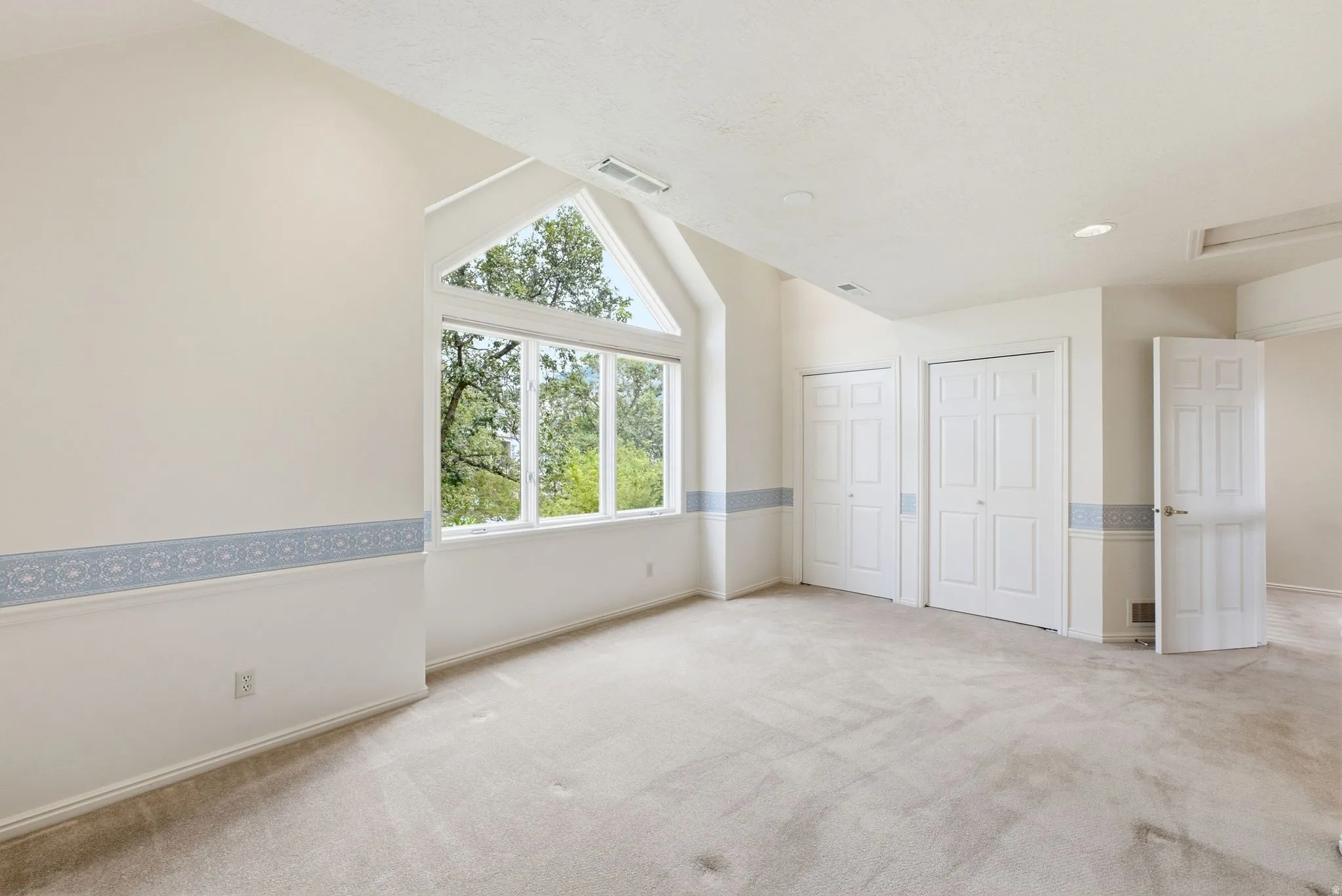 Vaulted ceilings with a prominent triangular window feature