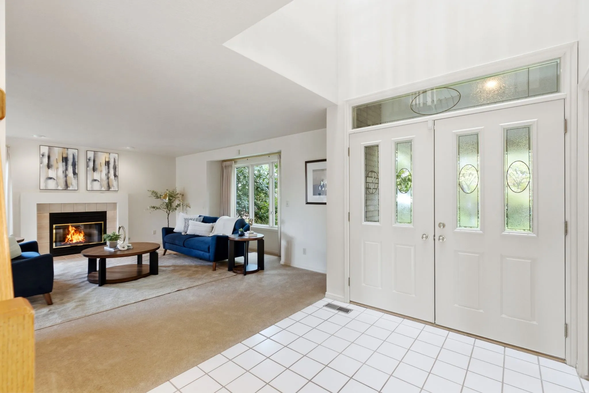 Double-door entry featuring decorative glass panels and transom window