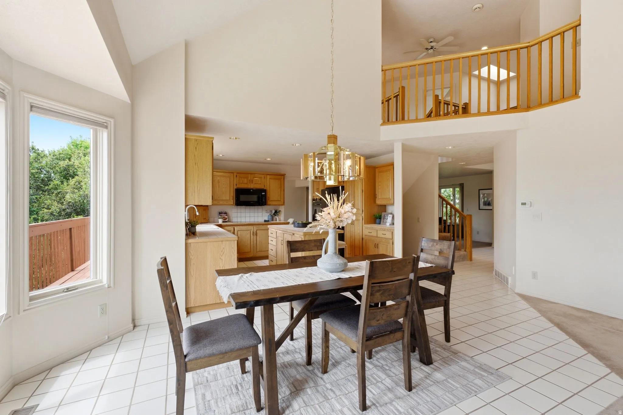 Open-concept dining area featuring a vaulted ceiling and an overhead decorative light fixture