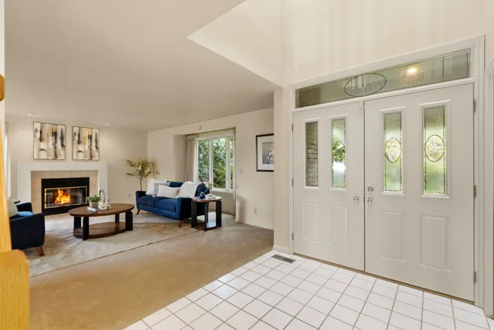 Double entry doors with decorative glass panels and transom window