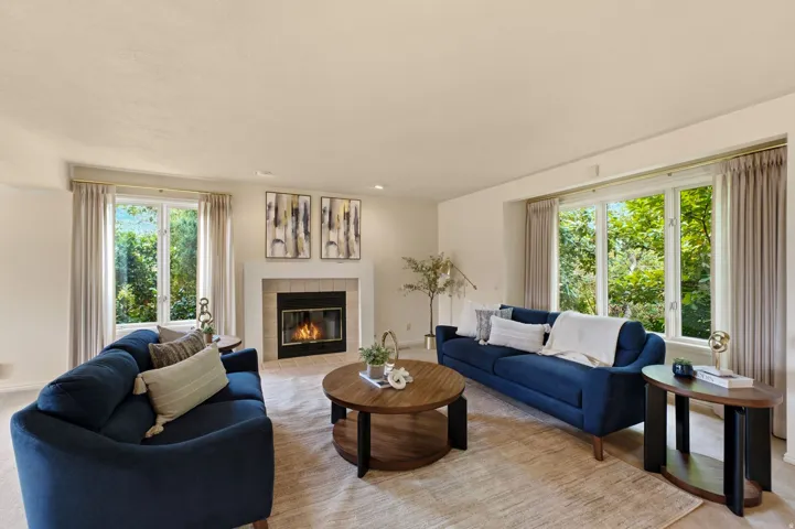 Living area with a fireplace, recessed lighting, and multiple windows