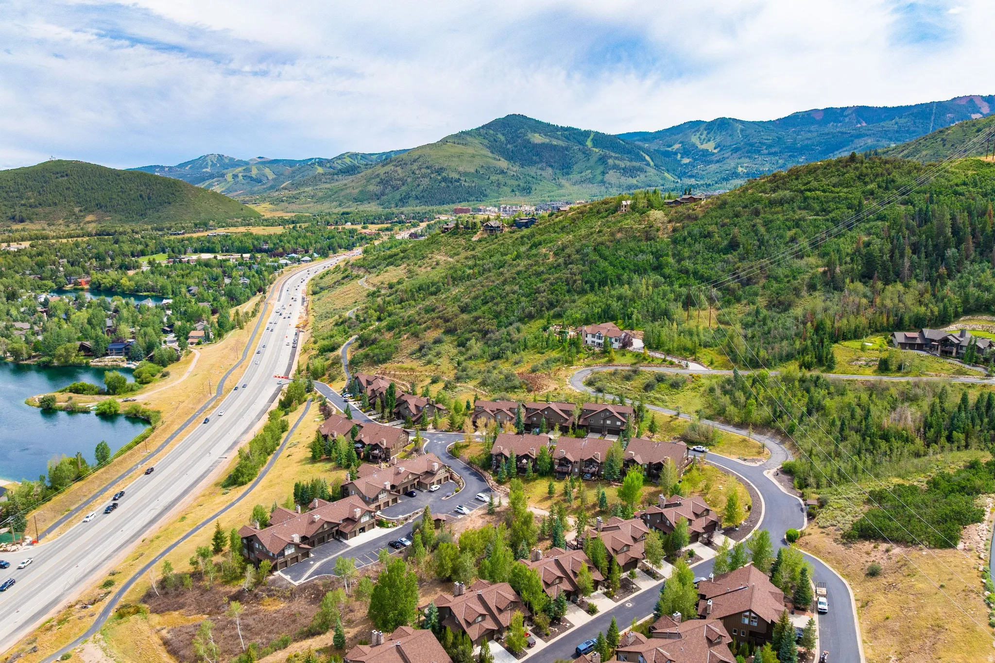 Aerial perspective showcasing a residential development nestled into a verdant hillside