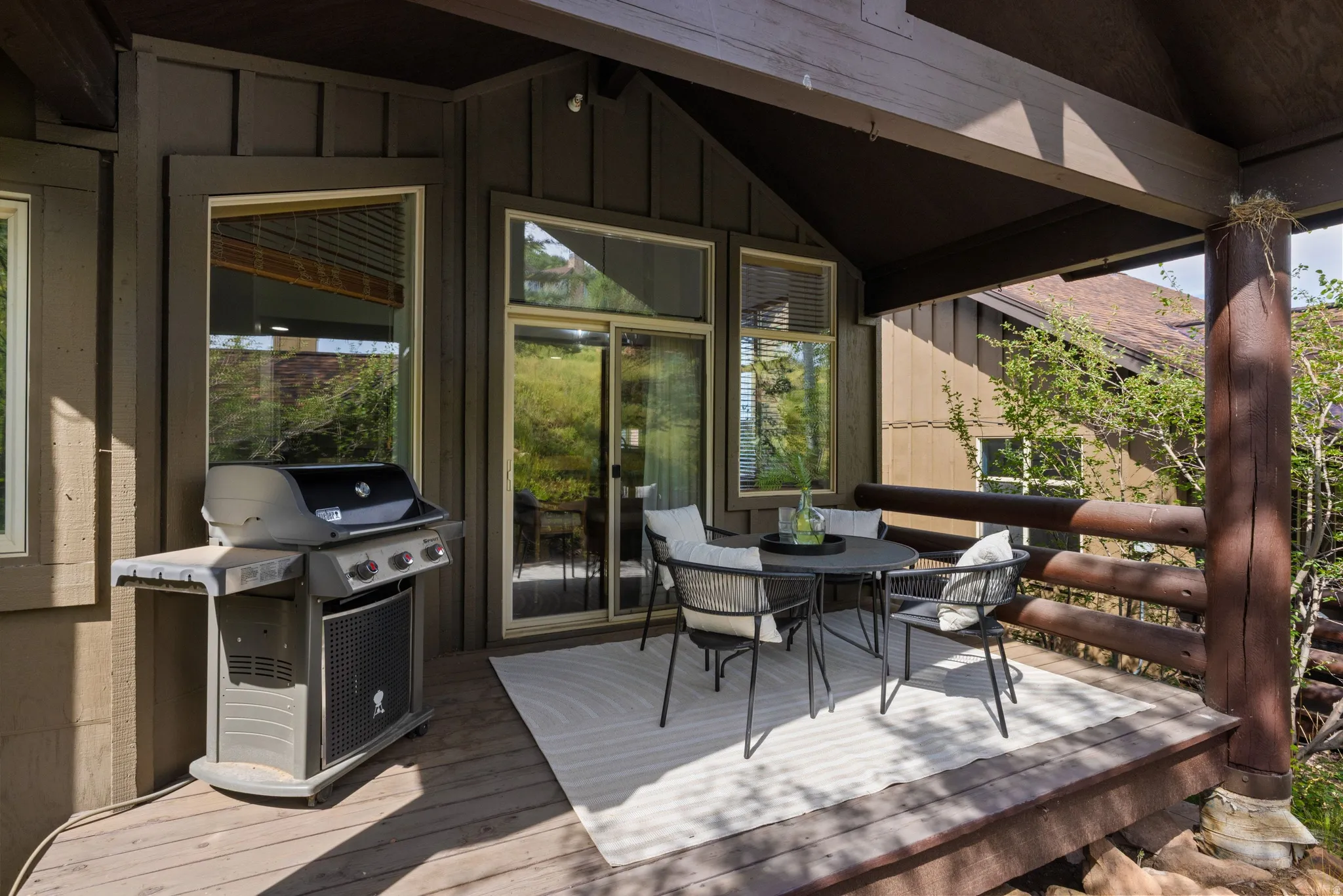 Inviting outdoor deck featuring a wood-finish floor, wood railing, and a covered ceiling