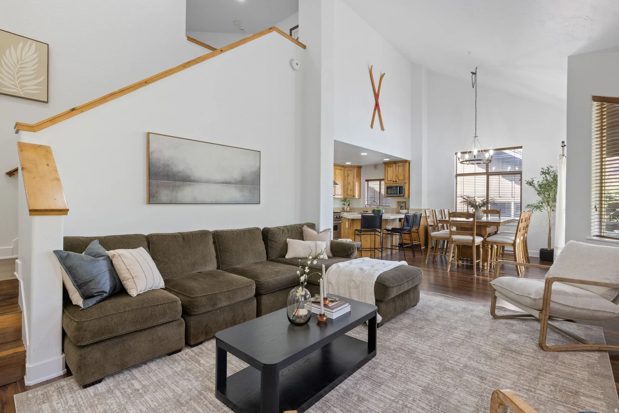Vaulted ceilings over a spacious living area featuring hardwood flooring