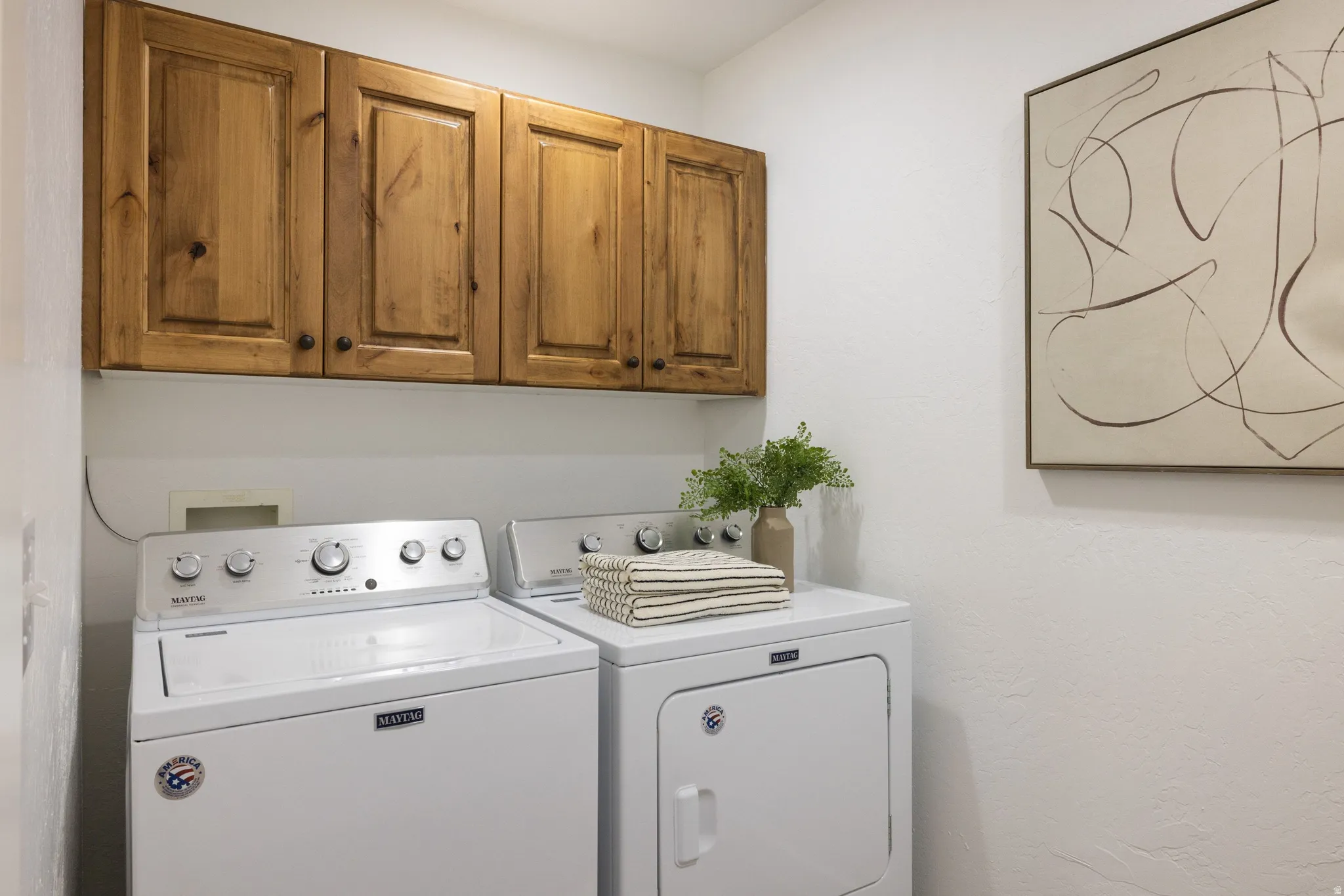 Upper cabinetry featuring natural wood paneling