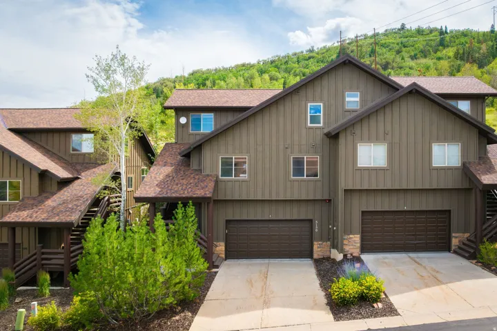 Contemporary townhouse exterior featuring vertical board siding in a neutral tone