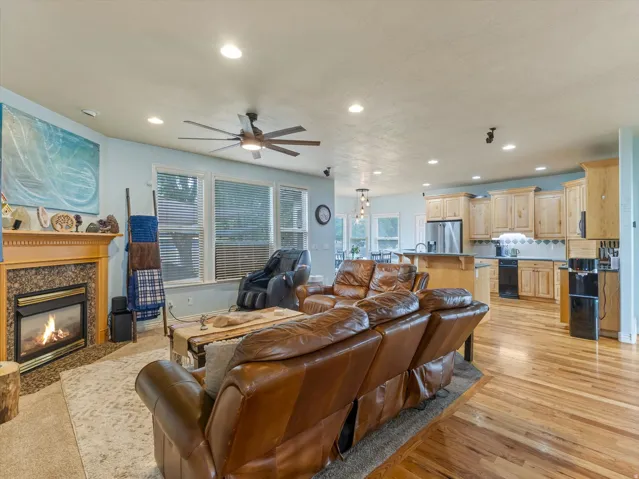 Living area with a fireplace featuring a wood mantel and stone surround