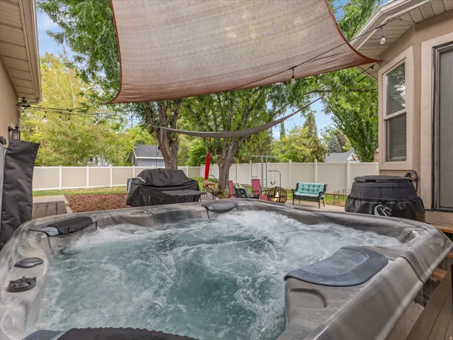 Outdoor hot tub with active jets, positioned on a wooden deck