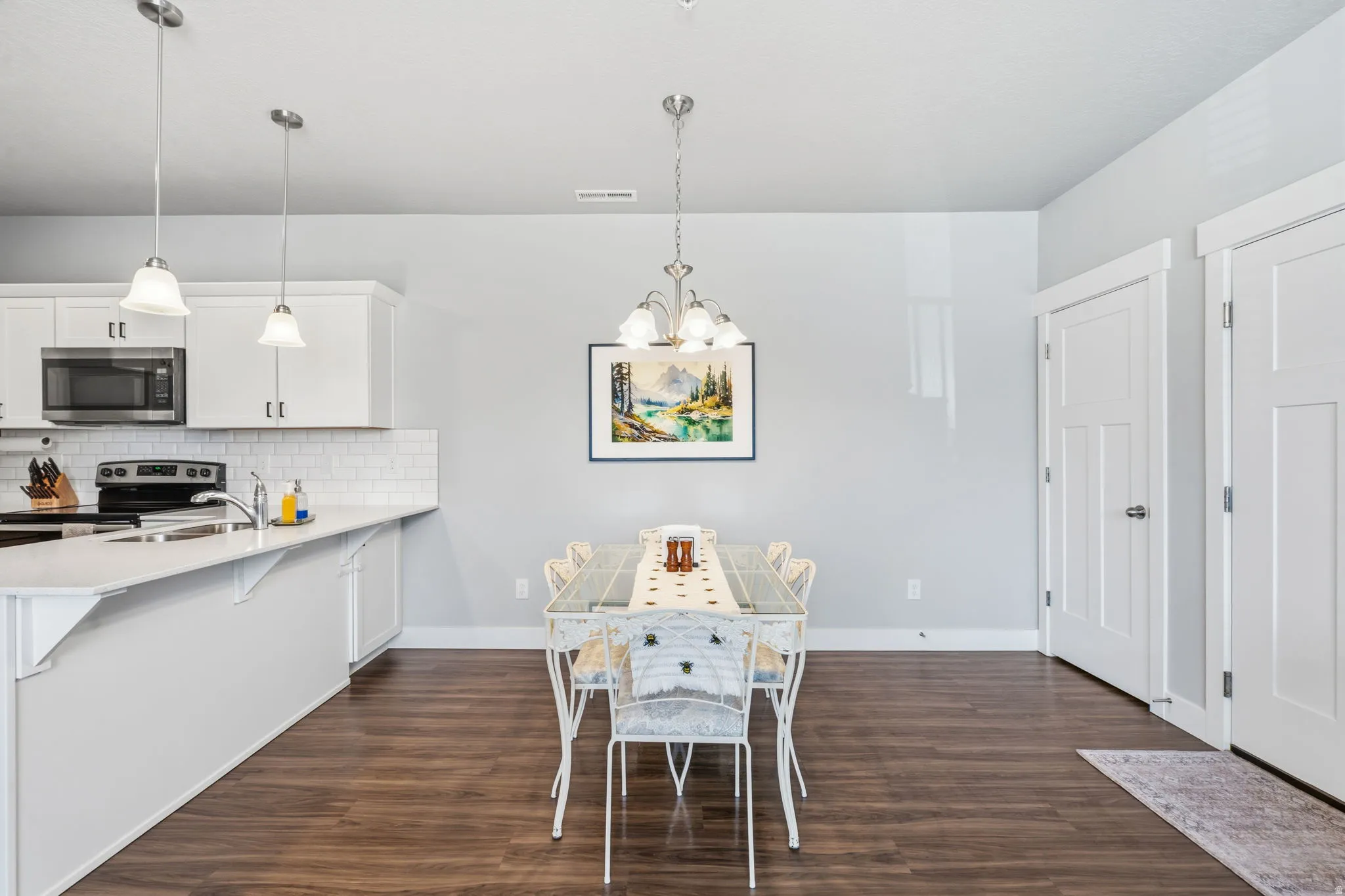 Open-concept kitchen and dining area featuring wood-finish flooring