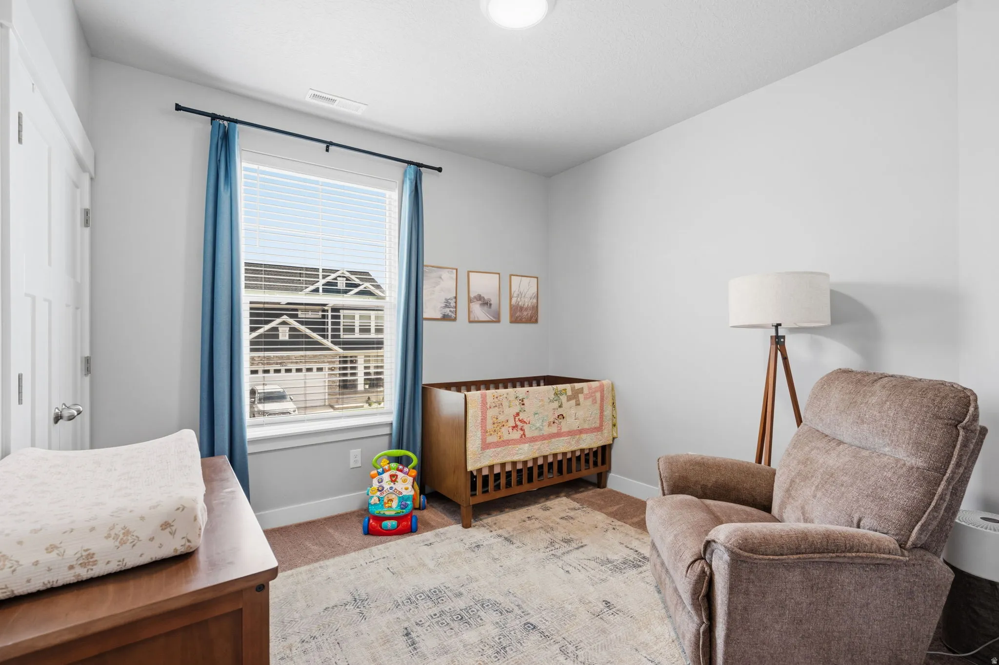 Bright room featuring neutral wall tones and a window with blinds