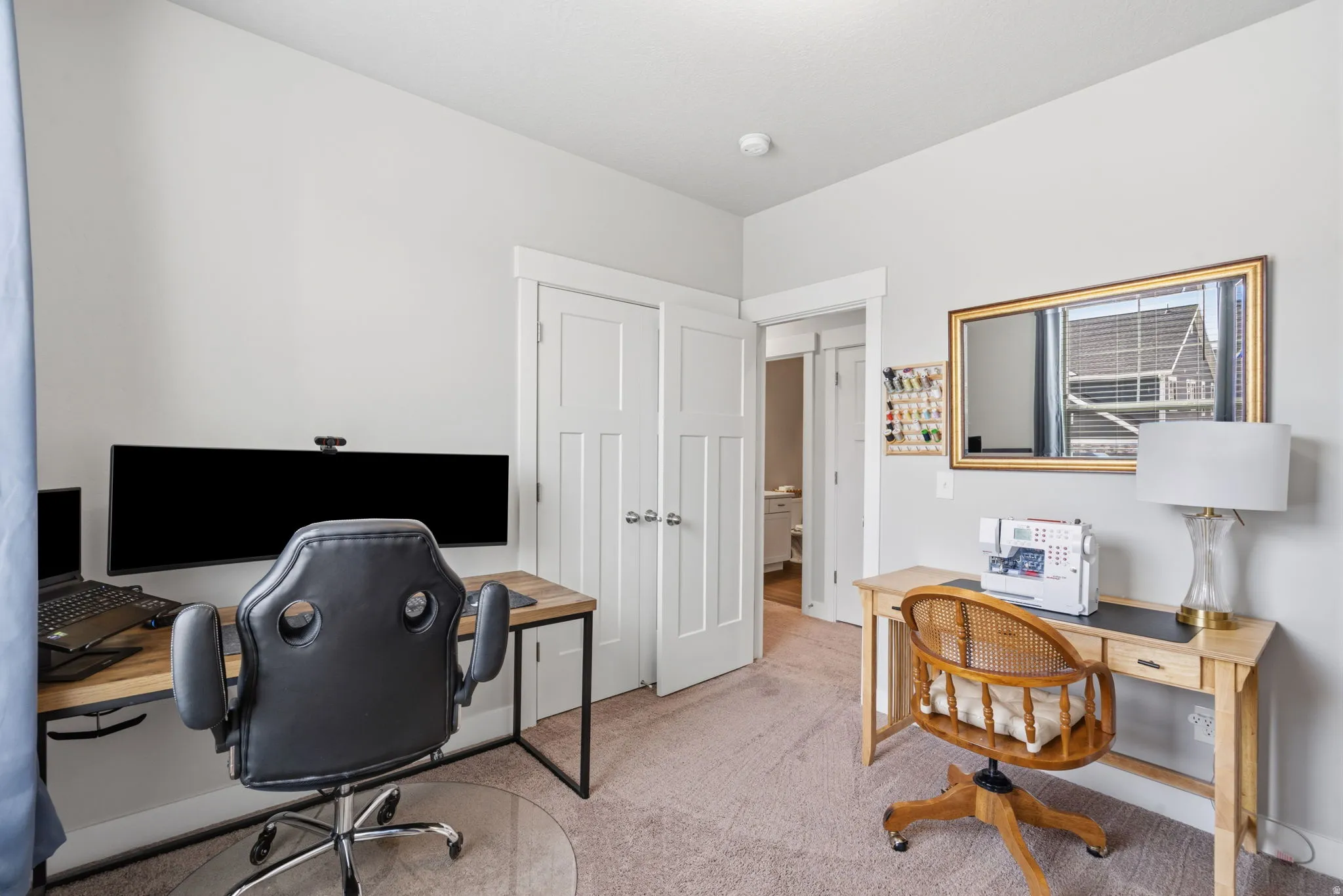 Versatile room with neutral wall tones and light-colored carpeting