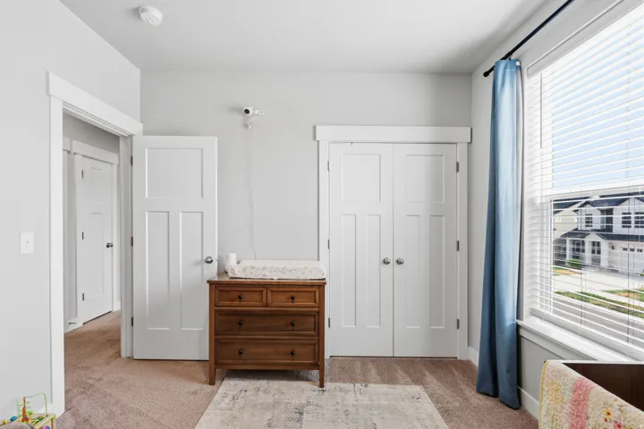 Light gray wall paint complemented by white trim and a neutral carpet