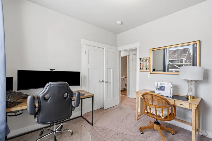 Versatile room with neutral wall tones and light-colored carpeting