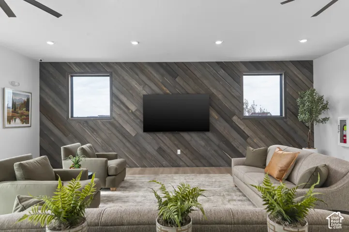 Accent wall featuring diagonally installed wood-finish panels and two modern windows