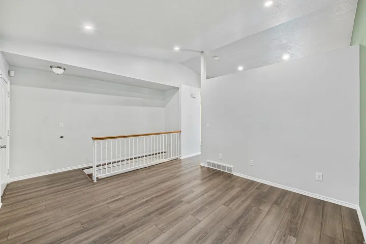 Open concept interior featuring wood-finish flooring and recessed ceiling lighting