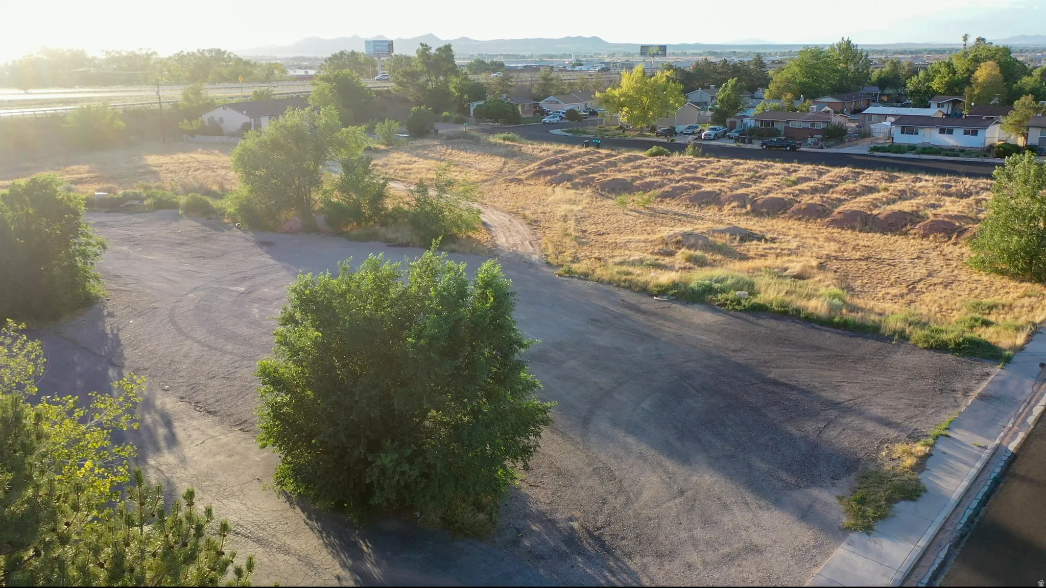 Expansive lot featuring a mix of paved and undeveloped land