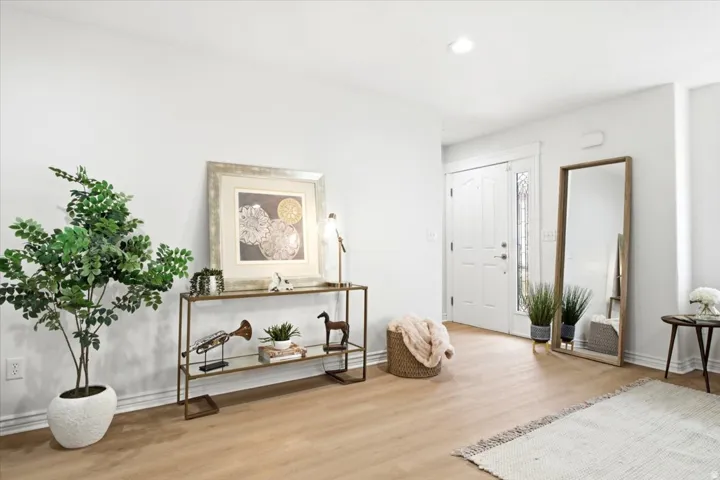 Entryway featuring wood-finish flooring, white baseboards, and bright white walls