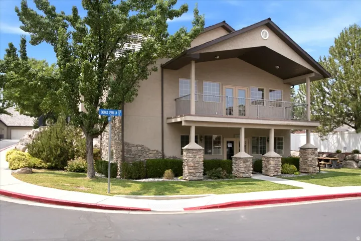 Two-story exterior featuring stucco siding and stone detailing