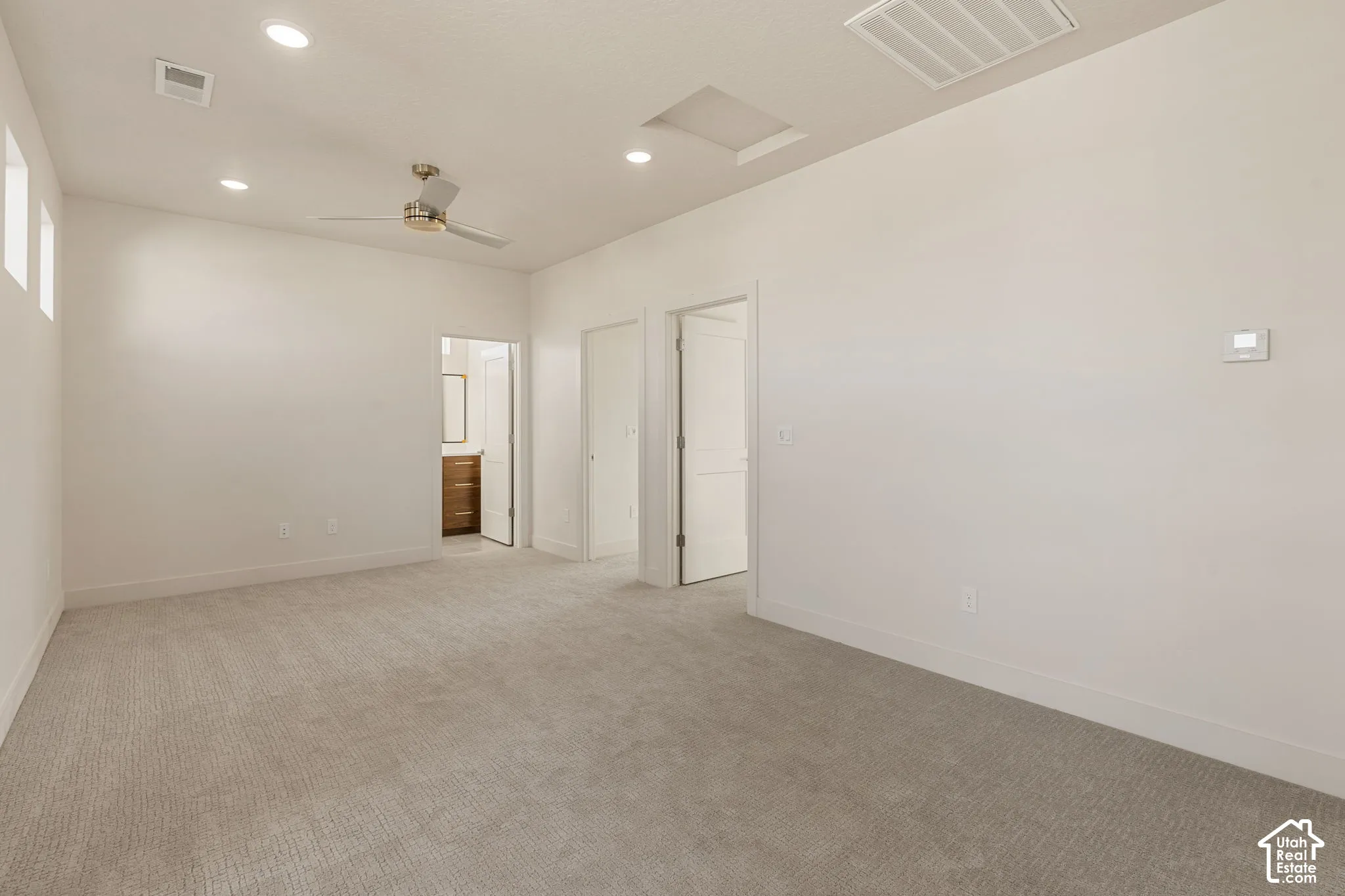Room featuring neutral wall-to-wall carpeting, recessed ceiling lighting, a multi-speed ceiling fan, and solid-core interior doors