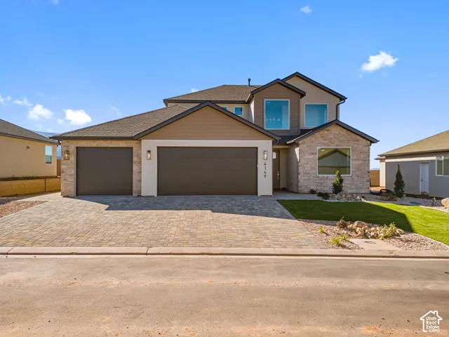 Multi-level exterior featuring a stone and siding facade, a paved driveway, and a three-car garage